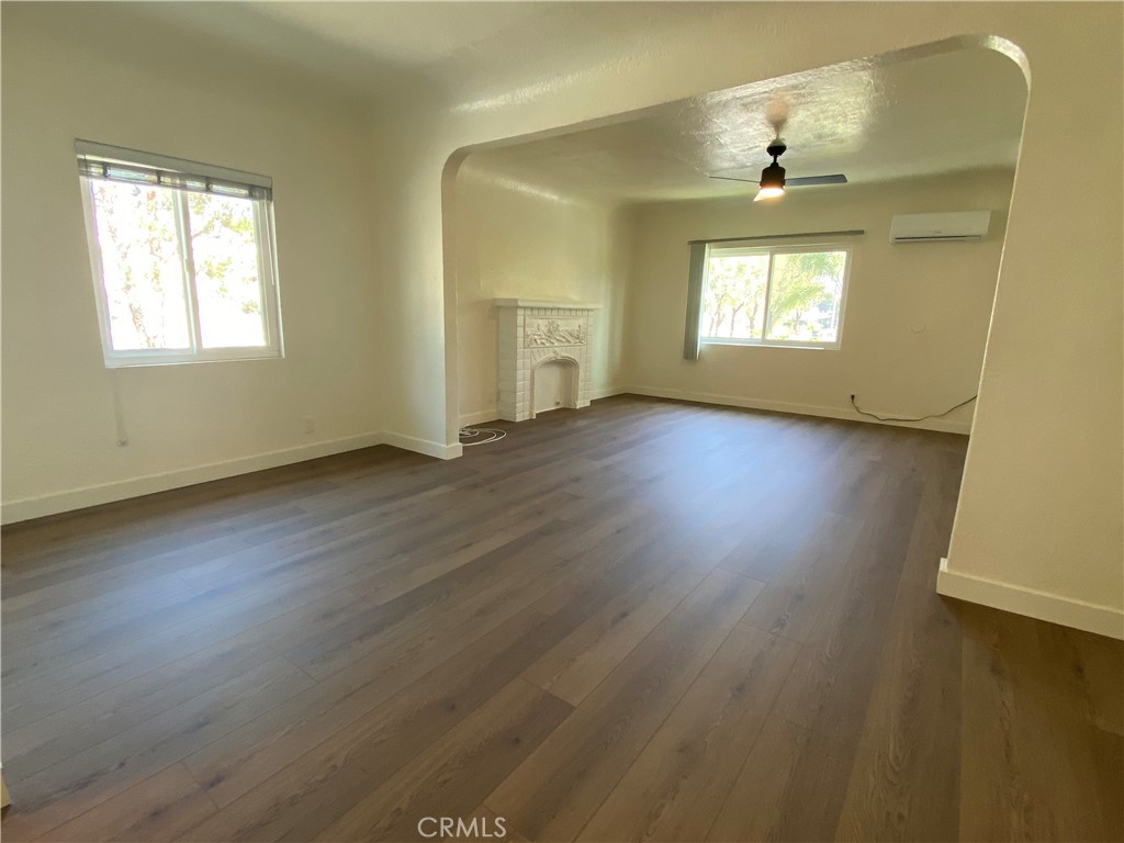 5103 Lindsey Avenue, Unit A Pico Rivera, CA 90660 - Photo 4 of 14 a view of an empty room with wooden floor and a window