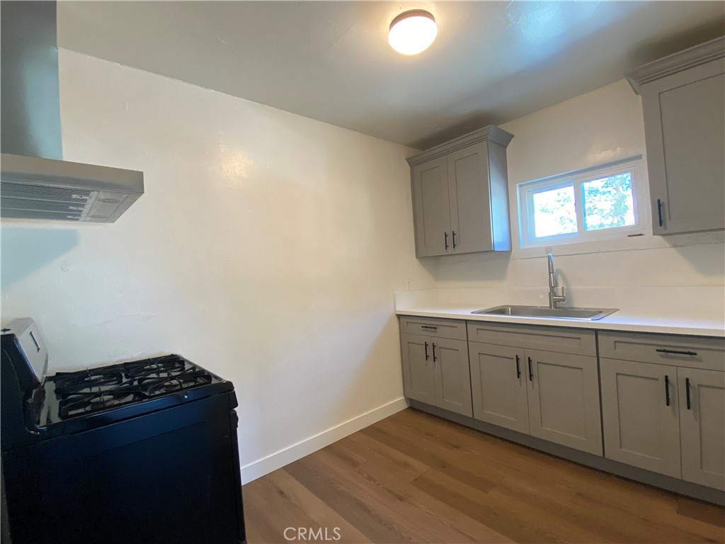 5103 Lindsey Avenue, Unit A Pico Rivera, CA 90660 - Photo 6 of 14 a kitchen with granite countertop cabinets and stove top oven