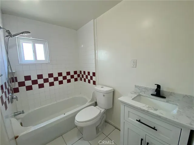 a bathroom with a sink a toilet and a bathtub