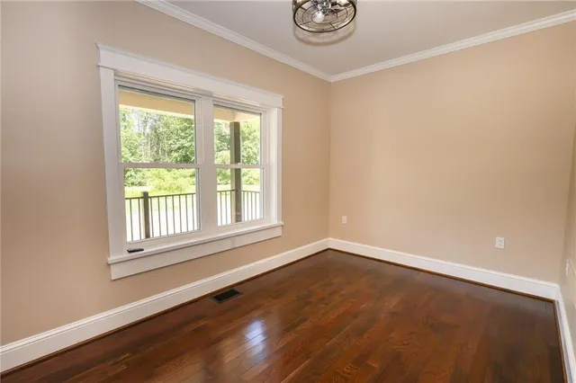 wooden floor in a room next to a window