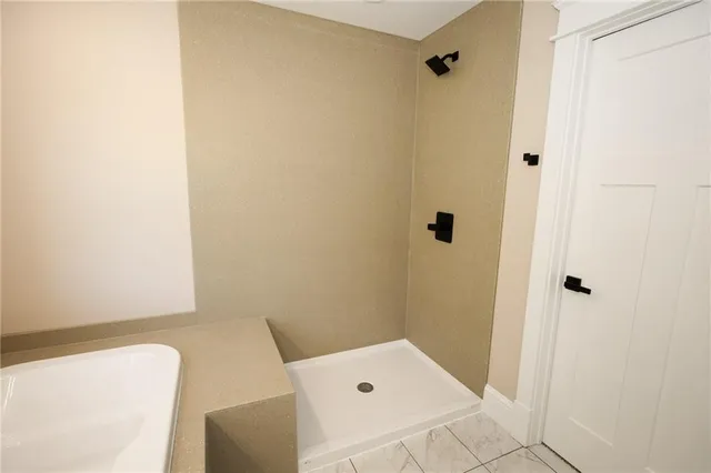 a bathroom with a tub and shower