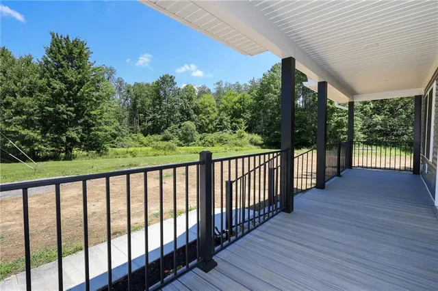 a balcony with wooden floor and outdoor space