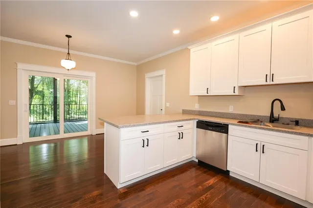 a kitchen with sink cabinets and wooden floor