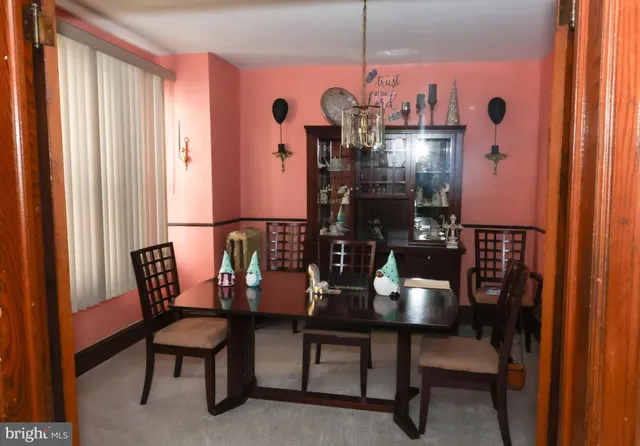 a view of a dining room with furniture and chandelier