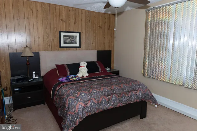 a bedroom with a bed and a lamp