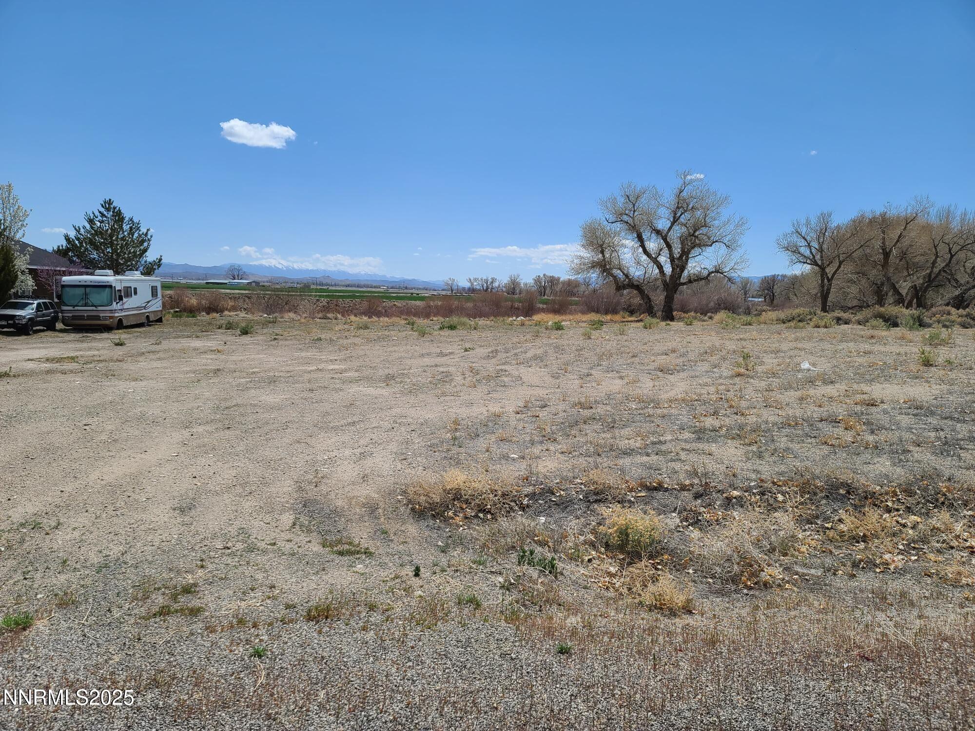 7 Margaroly Way Yerington, NV 89447 - Photo 3 of 9 a view of a dry yard with a car parked