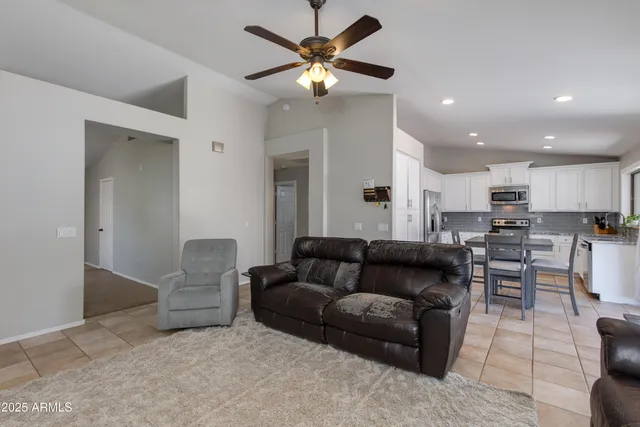 a living room with furniture and kitchen view