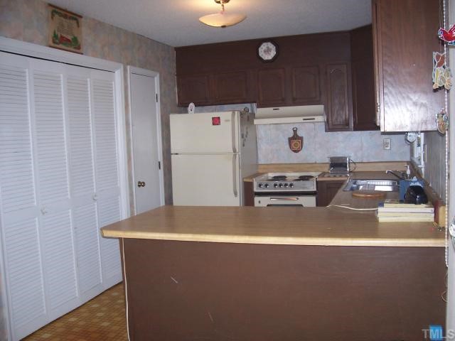 4832 Buffalo Road Selma, NC 27576 - Photo 6 of 12 Washer dryer behind louvered doors and pantry beside that.