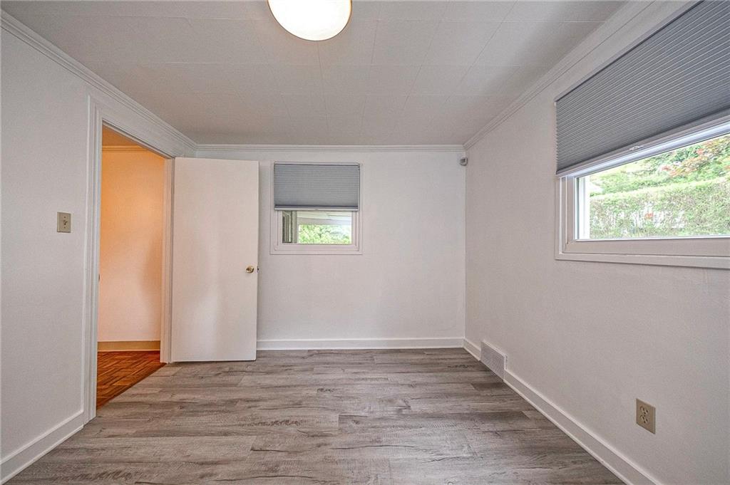 531 Laughlin Avenue Pittsburgh, PA 15210 - Photo 15 of 35 a view of an empty room with wooden floor and a window