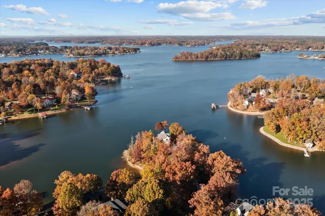 an aerial view of a houses with ocean view