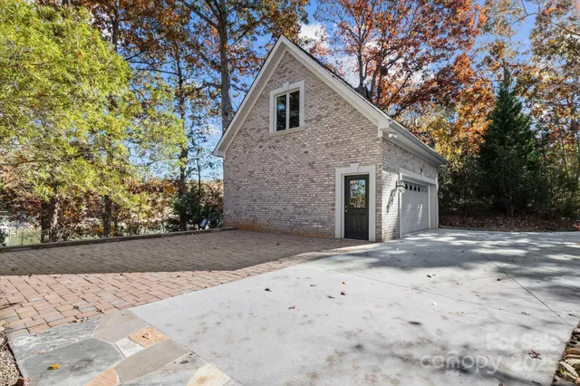 a view of a house with pool and lake view