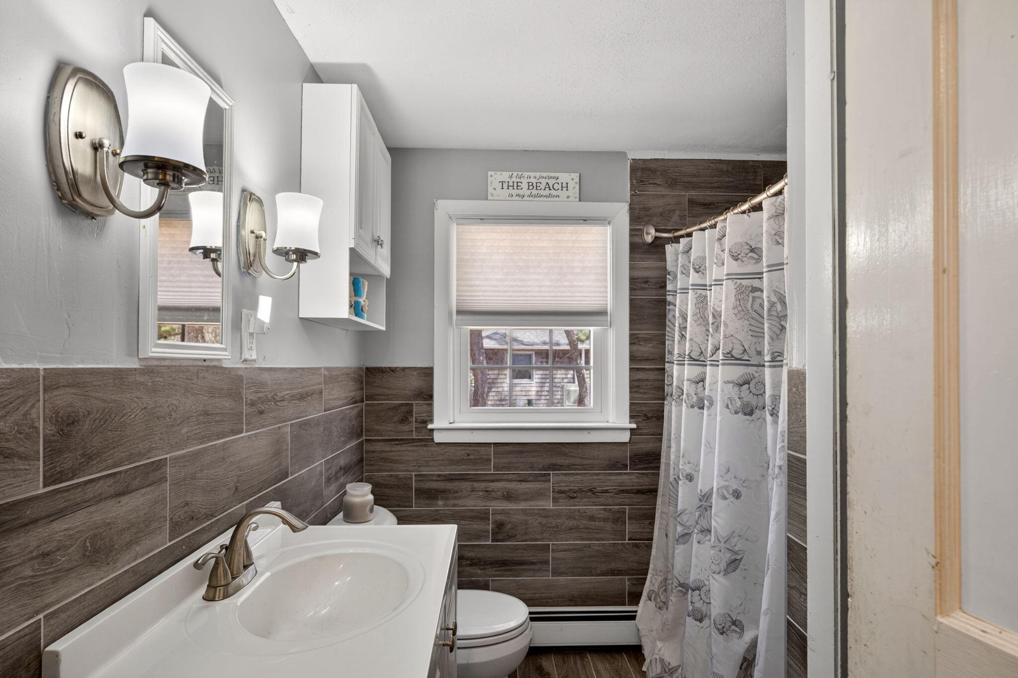 20 Fresh Brook Lane, Unit A Wellfleet, MA 02667 - Photo 13 of 35 a bathroom with a sink a toilet and shower