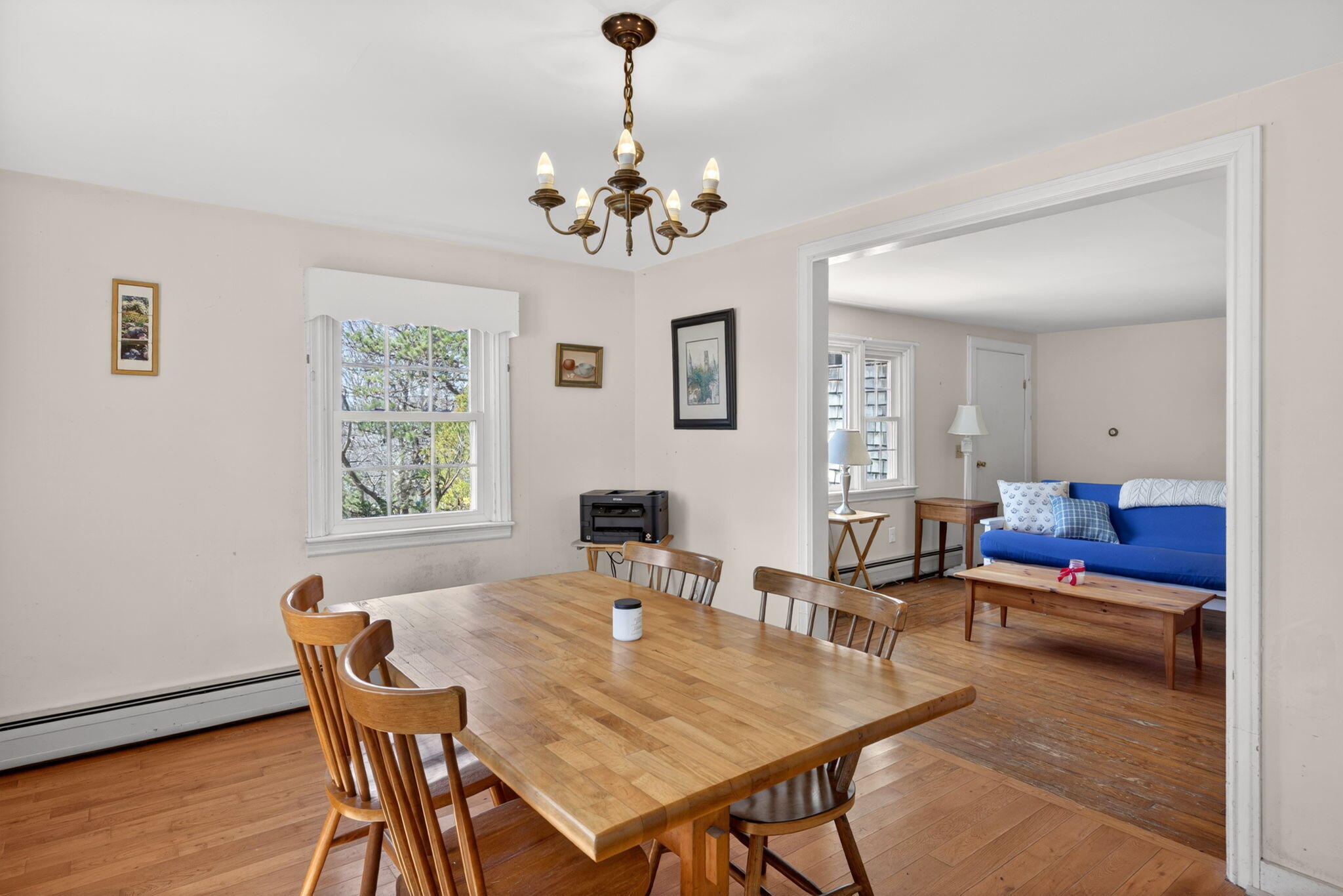 20 Fresh Brook Lane, Unit A Wellfleet, MA 02667 - Photo 7 of 35 a view of a dining room with furniture and a chandelier