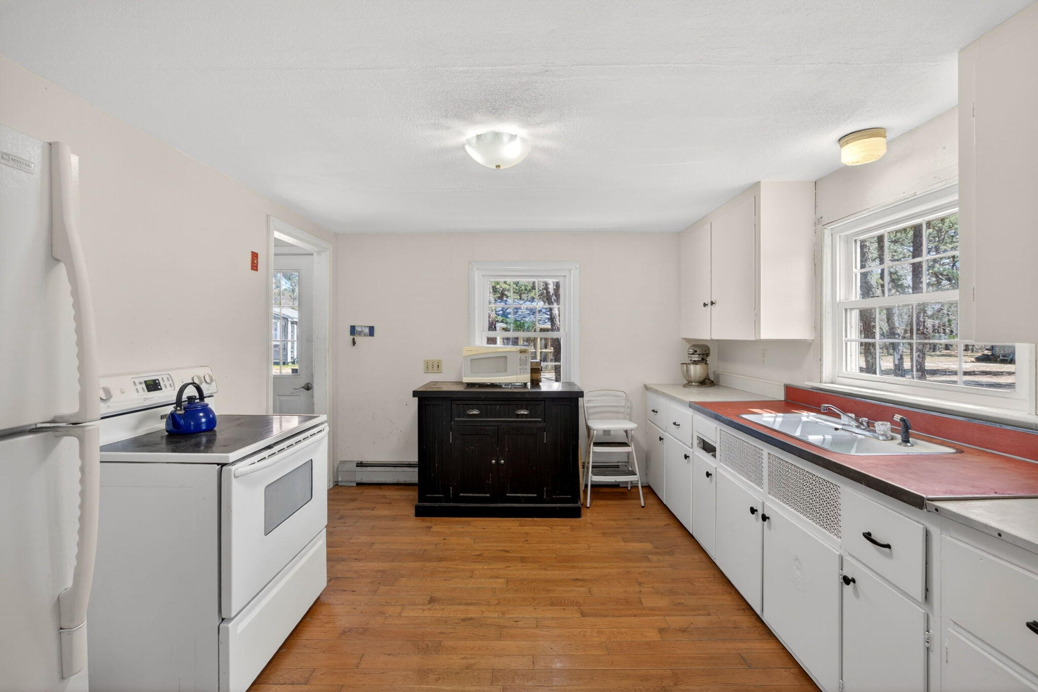 20 Fresh Brook Lane, Unit A Wellfleet, MA 02667 - Photo 8 of 35 a kitchen with stainless steel appliances a sink stove and cabinets