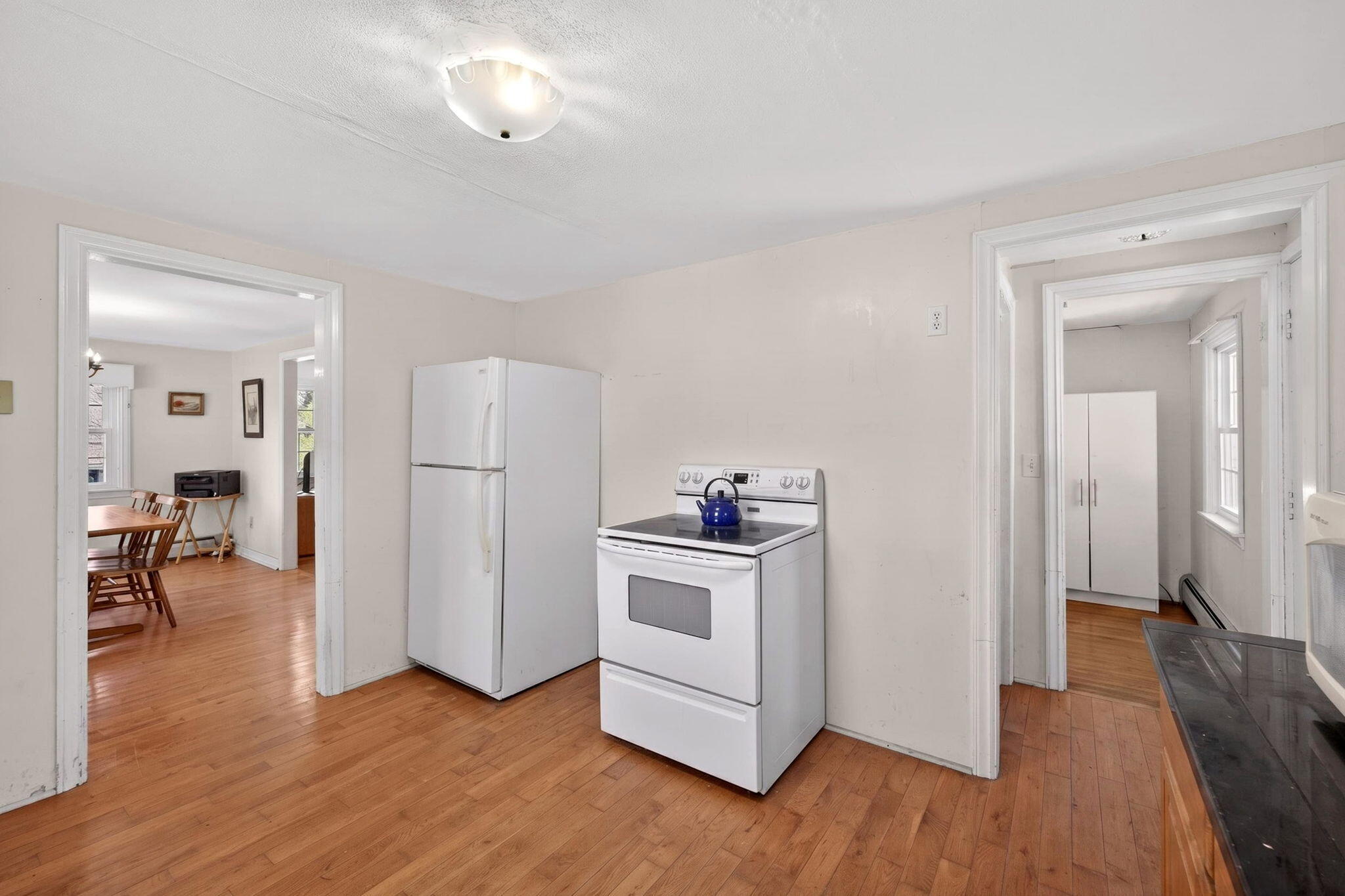 20 Fresh Brook Lane, Unit A Wellfleet, MA 02667 - Photo 10 of 35 a view of a kitchen with a white cabinets and wooden floor