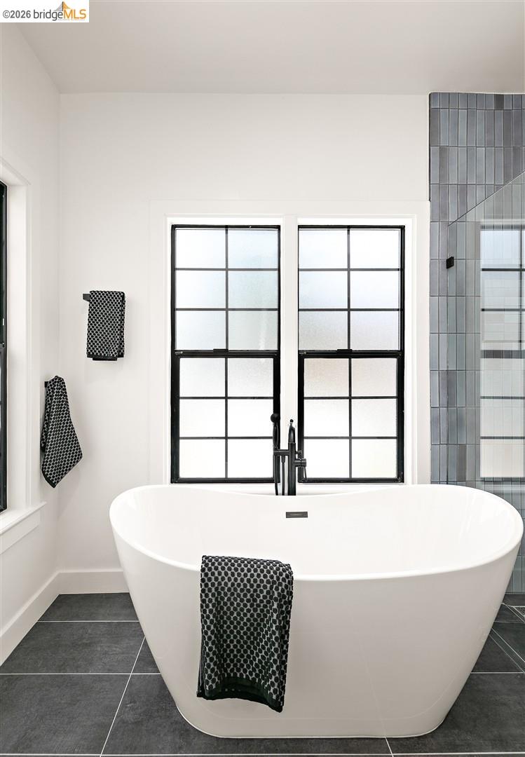 1668 Arch Street Berkeley, CA 94709 - Photo 32 of 78 Freestanding soaking tub with a floor-mounted matte black faucet