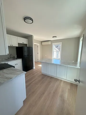 a view of a kitchen with a sink and a refrigerator