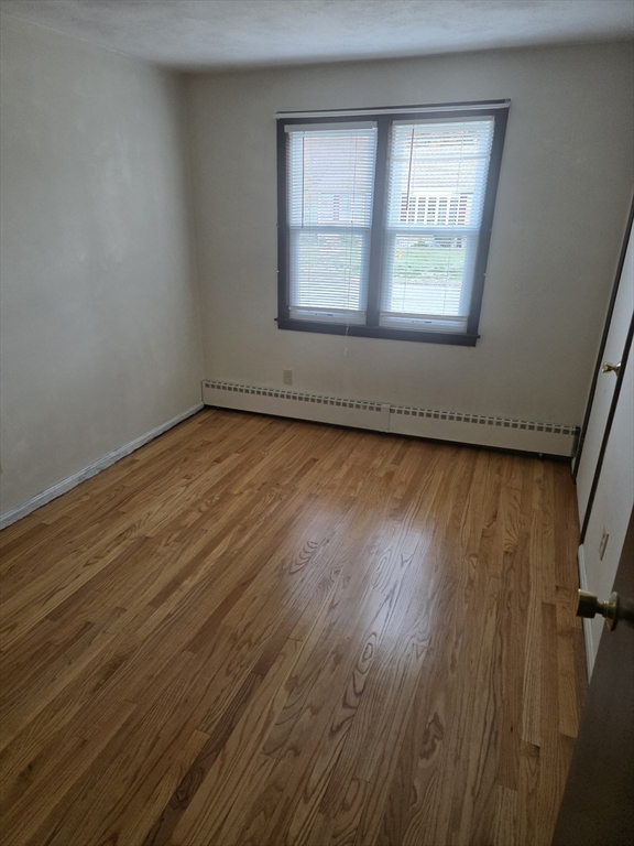 80 Ann Street Chicopee, MA 01020 - Photo 6 of 20 a view of an empty room with wooden floor and a window