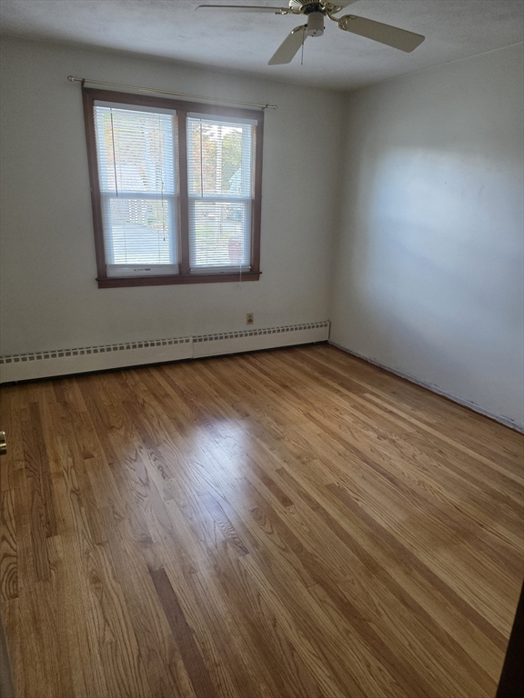 80 Ann Street Chicopee, MA 01020 - Photo 8 of 20 an empty room with wooden floor and windows