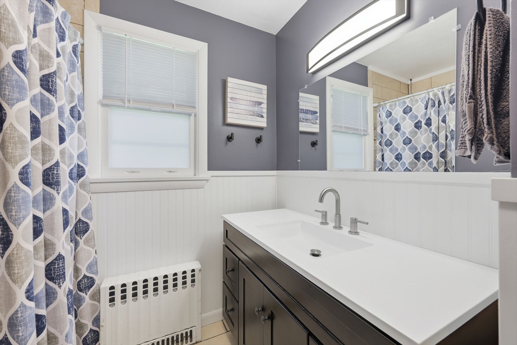 20 Connolly Street Springfield, MA 01151 - Photo 29 of 41 a bathroom with a sink a mirror and a shower