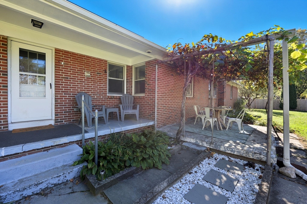 20 Connolly Street Springfield, MA 01151 - Photo 37 of 41 a view of a porch with chairs and potted plants