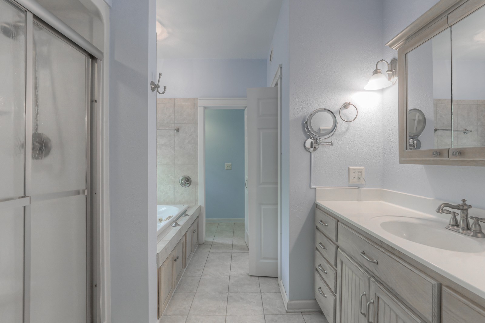 807 Timberwood Trace Monteagle, TN 37356 - Photo 23 of 64 a spacious bathroom with a granite countertop sink a mirror and a shower