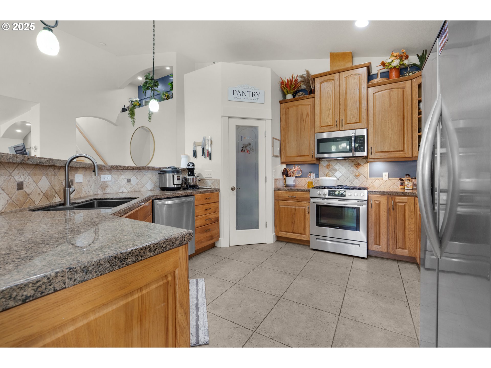 2344 Royal View Drive Seaside, OR 97138 - Photo 18 of 38 a kitchen with stainless steel appliances granite countertop a sink a stove and a refrigerator