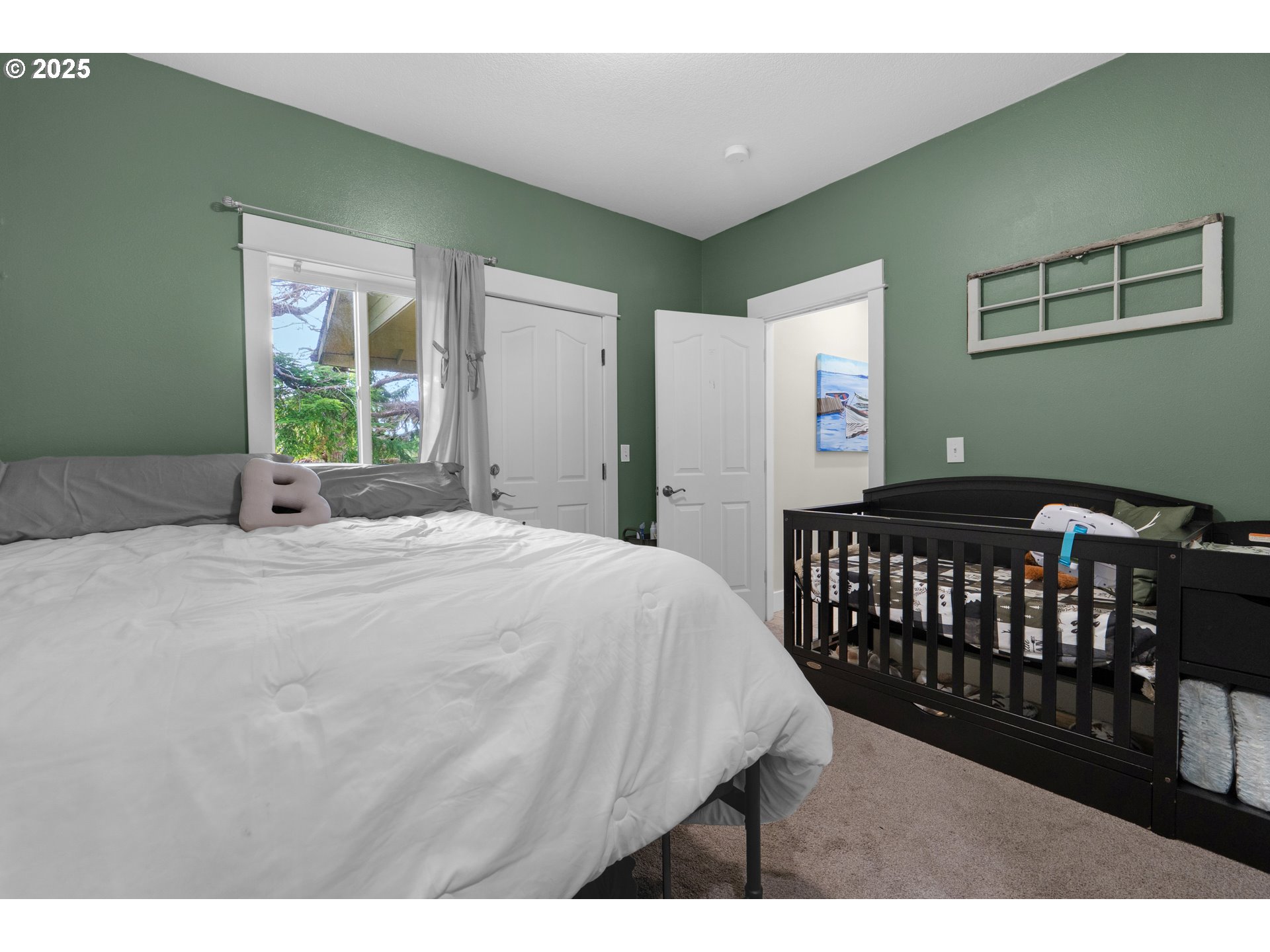 2344 Royal View Drive Seaside, OR 97138 - Photo 33 of 38 a bedroom with a bed window and a wall painting