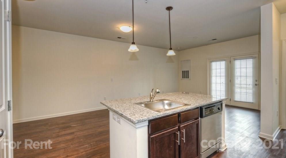 4310 Park Road, Unit 206 Charlotte, NC 28209 - Photo 5 of 13 a bathroom with a granite countertop sink and a mirror
