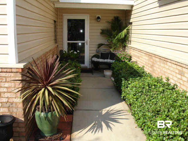 1517 Regency Road, Unit 123 Gulf Shores, AL 36542 - Photo 2 of 31 WALK WAY TO NEW STORM DOOR WITH HIDDEN SCREEN