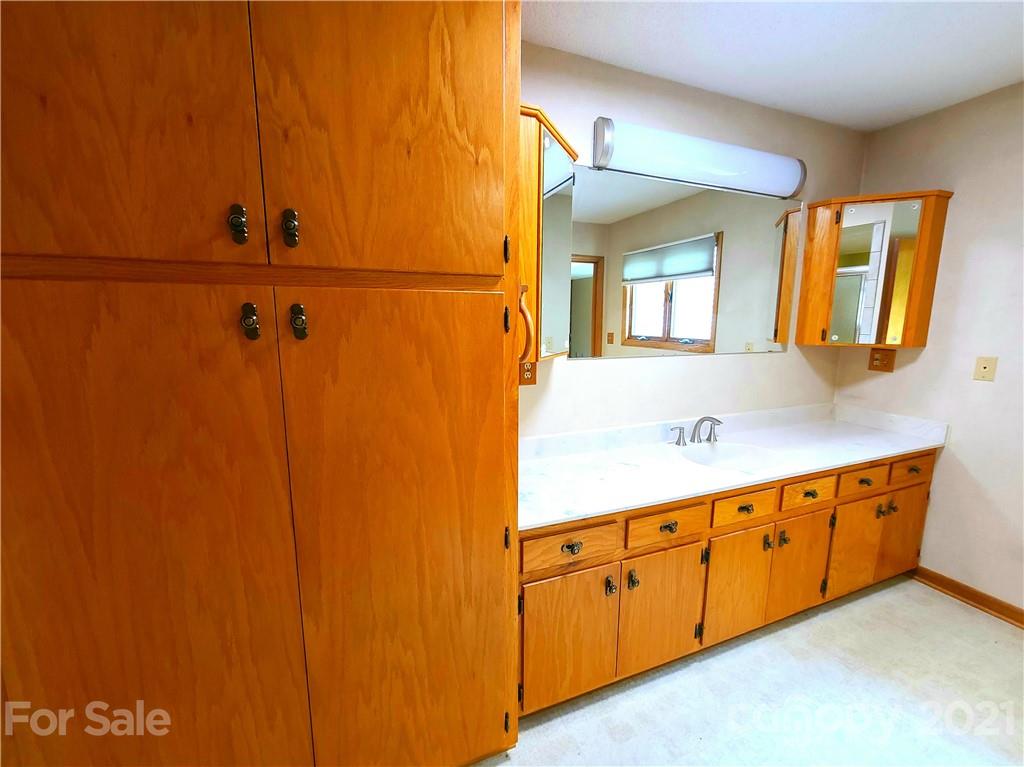 250 Tanner Street Rutherfordton, NC 28139 - Photo 22 of 48 a bathroom with a double vanity sink and mirror