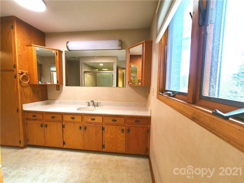 250 Tanner Street Rutherfordton, NC 28139 - Photo 25 of 48 a bathroom with a tub sink and mirror