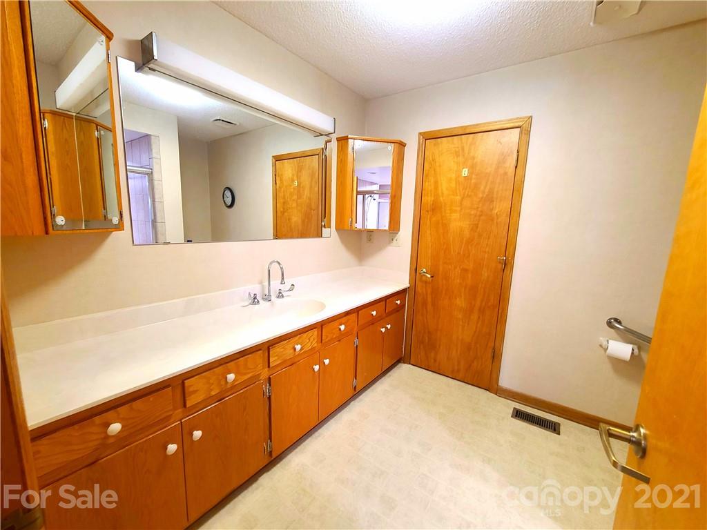 250 Tanner Street Rutherfordton, NC 28139 - Photo 28 of 48 a spacious bathroom with a granite countertop sink and a mirror