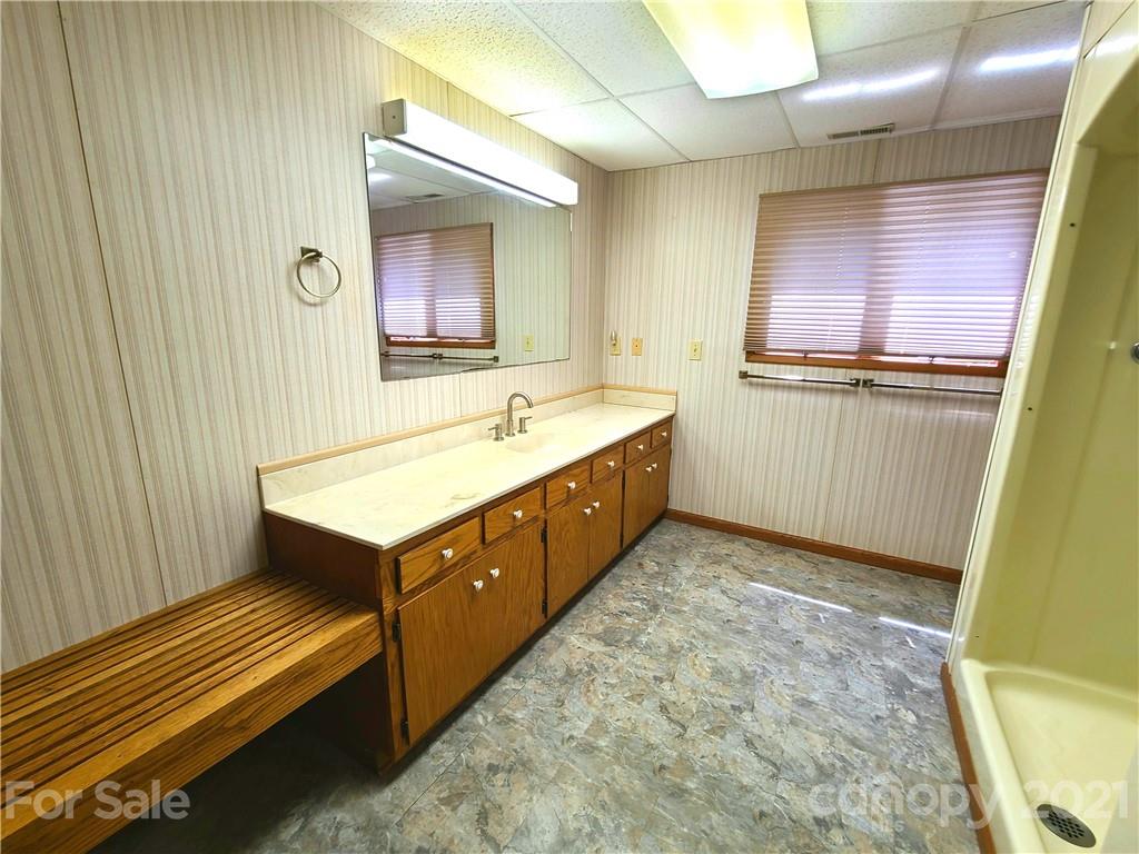 250 Tanner Street Rutherfordton, NC 28139 - Photo 41 of 48 a bathroom with a sink a mirror and a bathtub