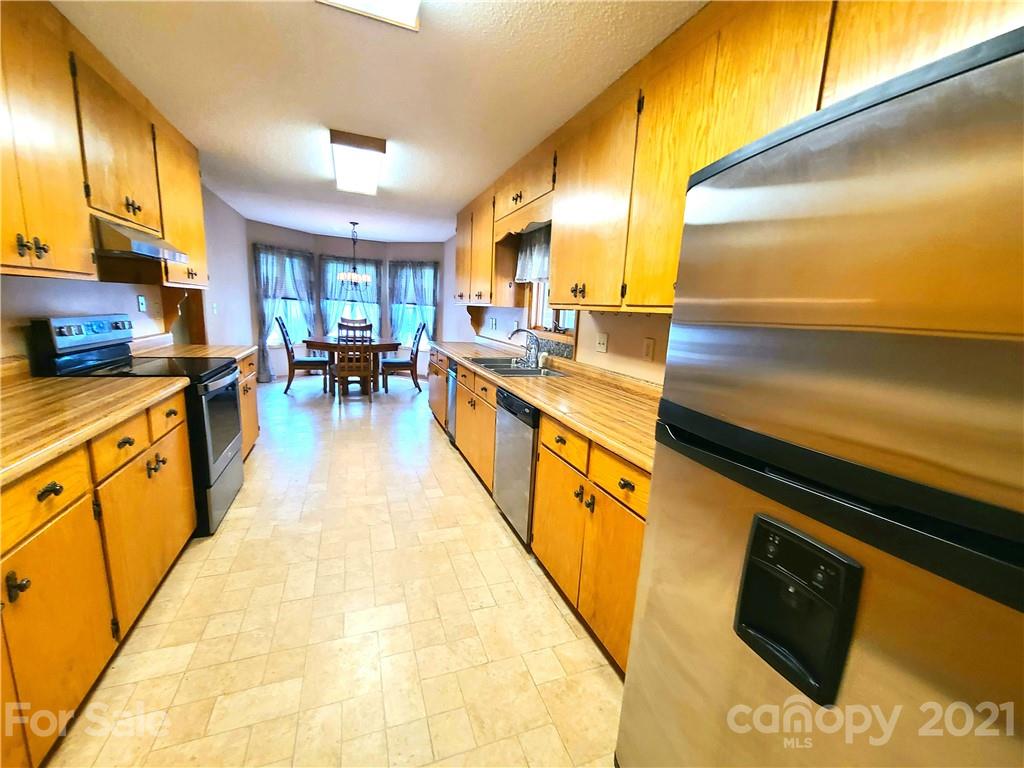250 Tanner Street Rutherfordton, NC 28139 - Photo 8 of 48 a large kitchen with stainless steel appliances granite countertop a barbecue grill and cabinets