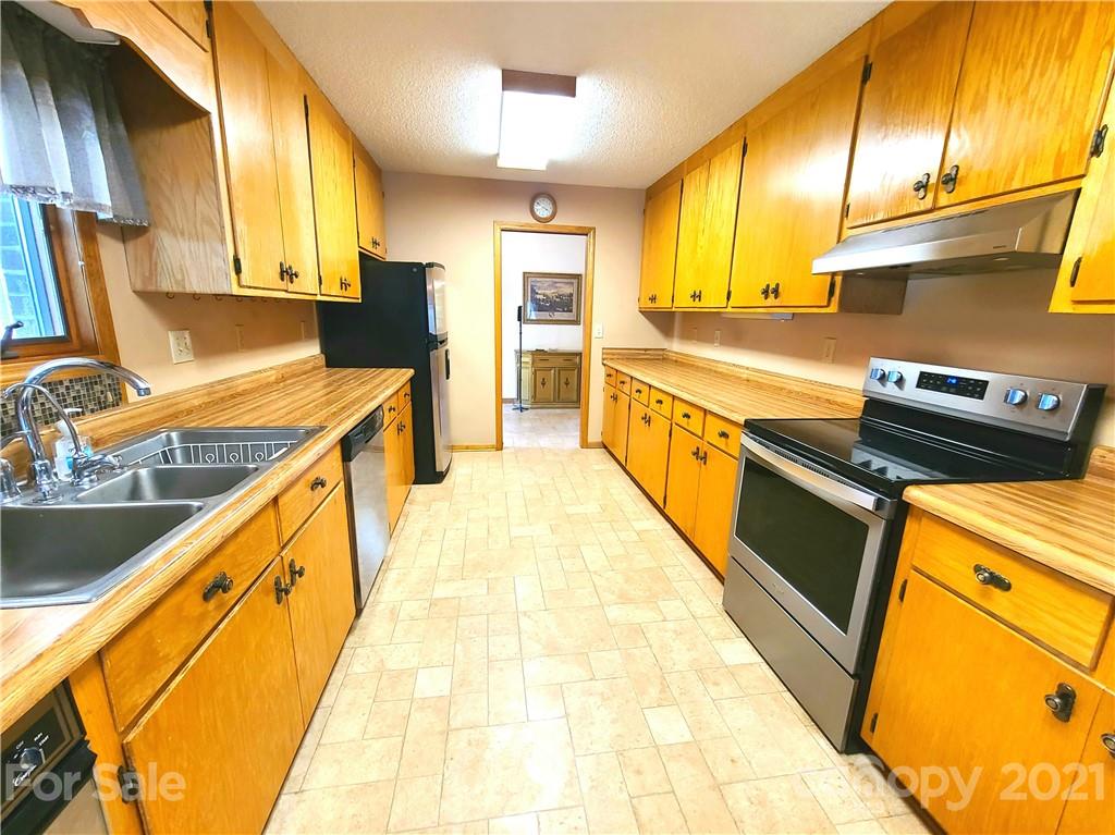 250 Tanner Street Rutherfordton, NC 28139 - Photo 10 of 48 a kitchen with stainless steel appliances granite countertop a sink a stove and a refrigerator