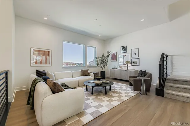 a living room with furniture or couch and a wooden floor