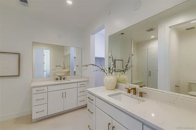 a bathroom with a double vanity sink and a mirror