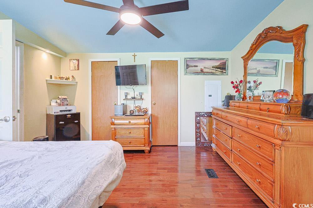 1911 Abba Court Conway, SC 29526 - Photo 13 of 25 Bedroom featuring wood-type flooring, vaulted ceiling, and a ceiling fan