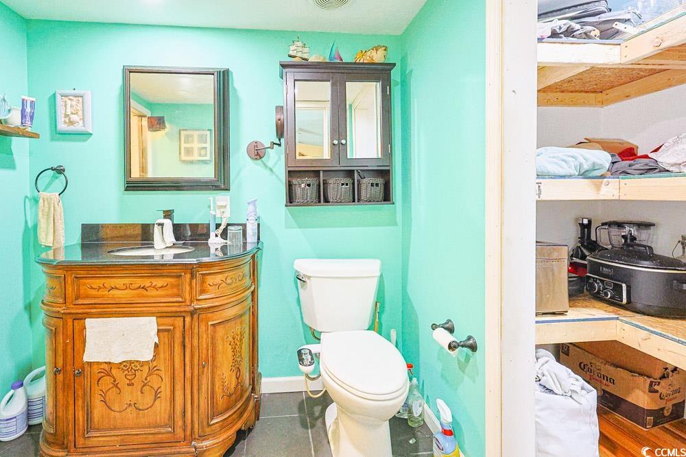1911 Abba Court Conway, SC 29526 - Photo 15 of 25 Bathroom featuring vanity, dark tile patterned flooring, and a stall shower