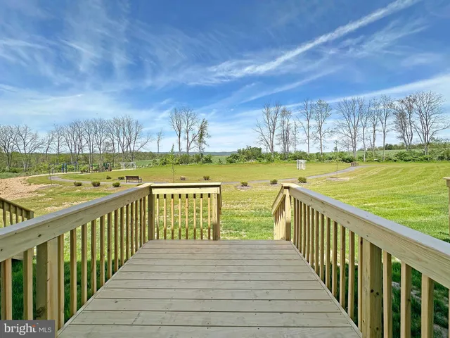 a view of a balcony with wooden floor and city view