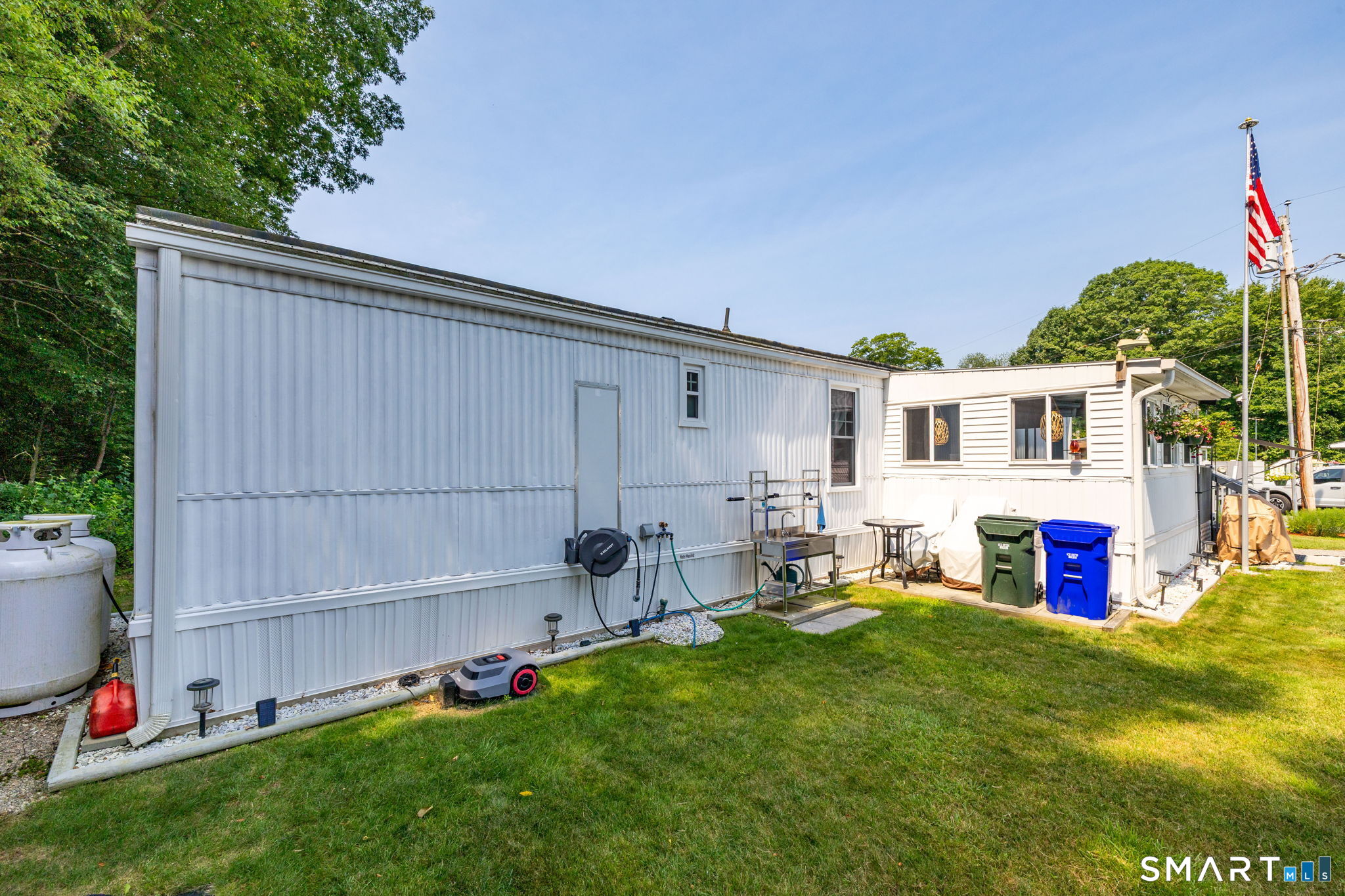 301 Buddington Road Groton, CT 06340 - Photo 25 of 34 a front view of house with yard and seating area