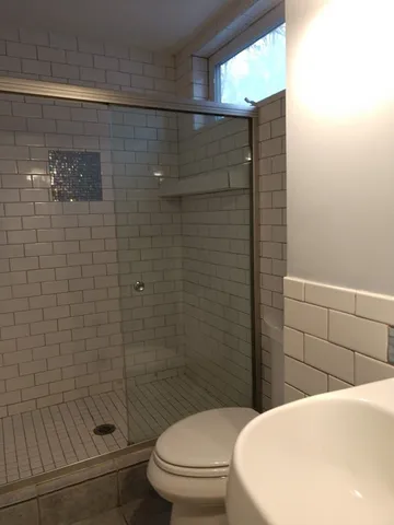 a bathroom with a toilet and shower
