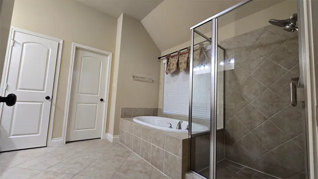 a bathroom with a bathtub and a shower