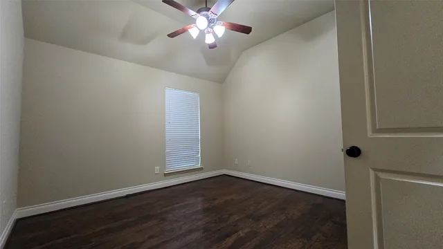 an empty room with wooden floor and closet