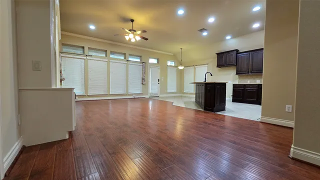 a kitchen with a sink a stove and a wooden cabinets