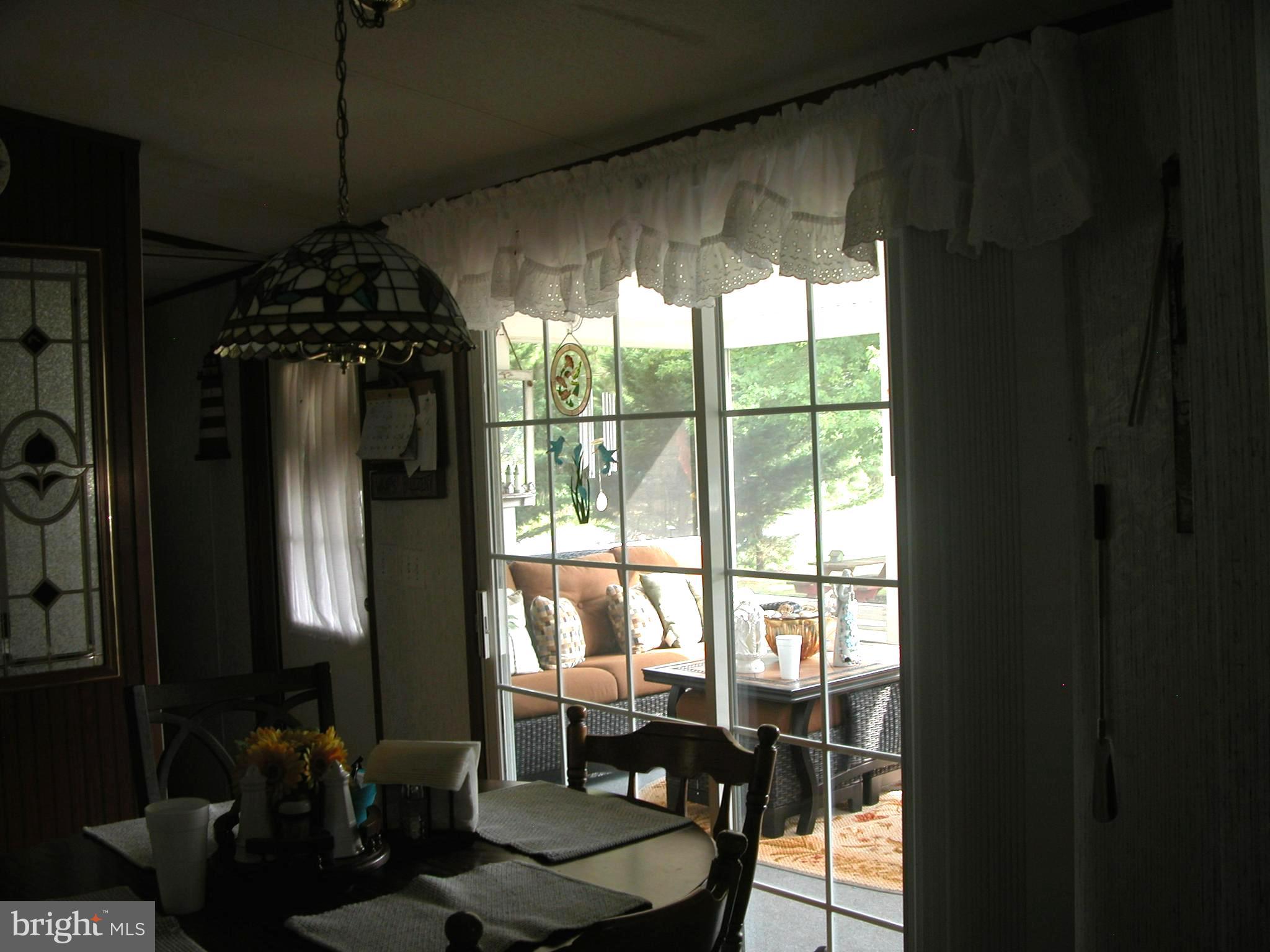 30961 Oakwood Road Ocean View, DE 19970 - Photo 8 of 30 slider in kitchen looking into porch
