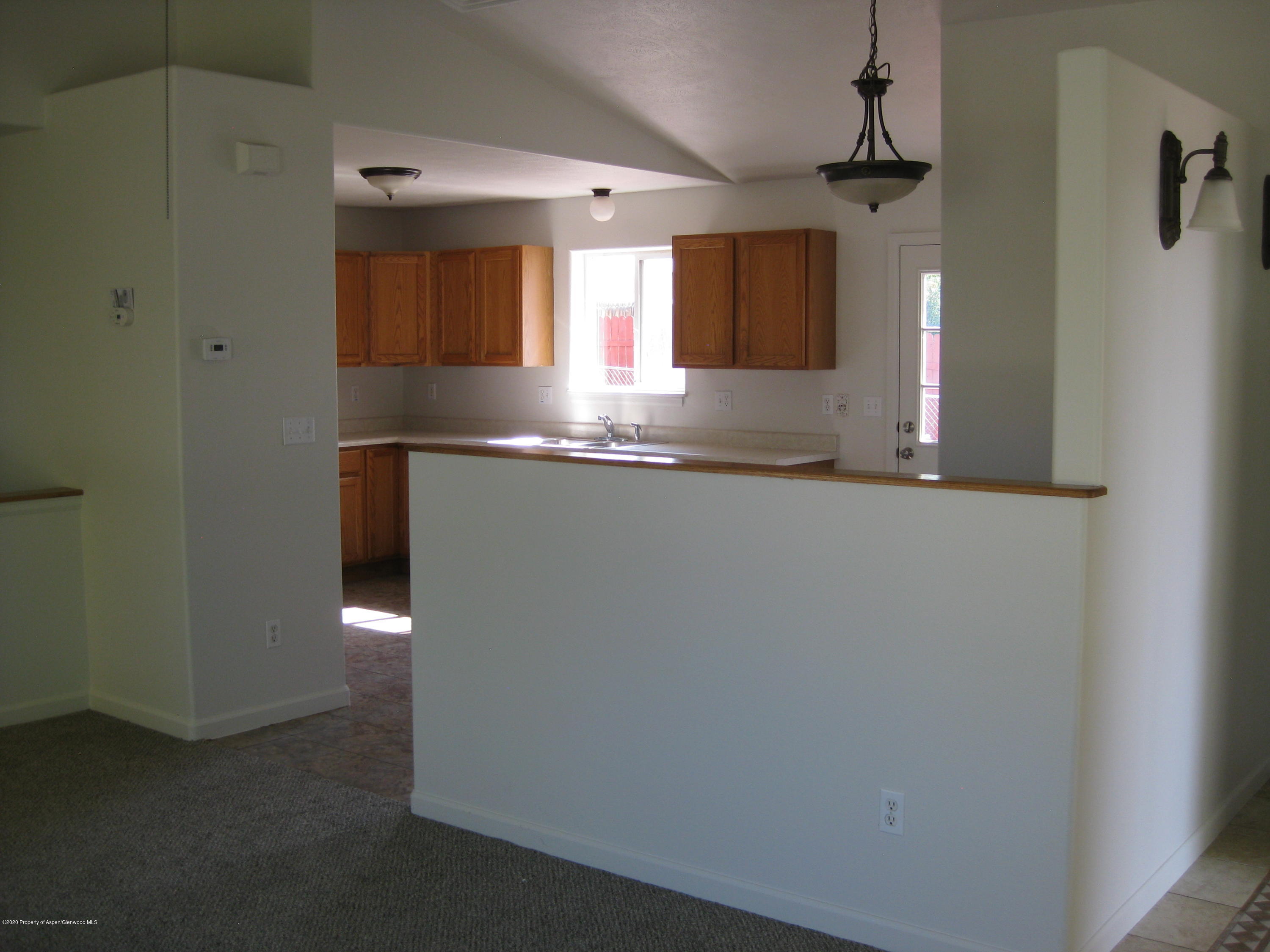 1588 Anvil View Avenue Rifle, CO 81650 - Photo 6 of 15 a kitchen with stainless steel appliances granite countertop a sink and a refrigerator
