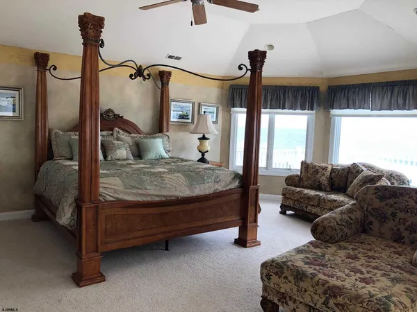 a view of a room with stairs and a floor to ceiling window