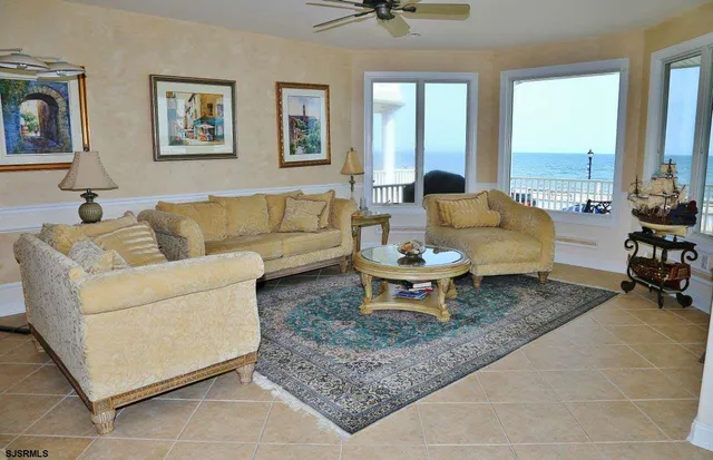 a kitchen with stainless steel appliances kitchen island granite countertop a table chairs sink and cabinets